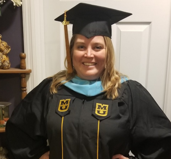 Tanya Deering, EdSp, wearing her graduation cap and gown.