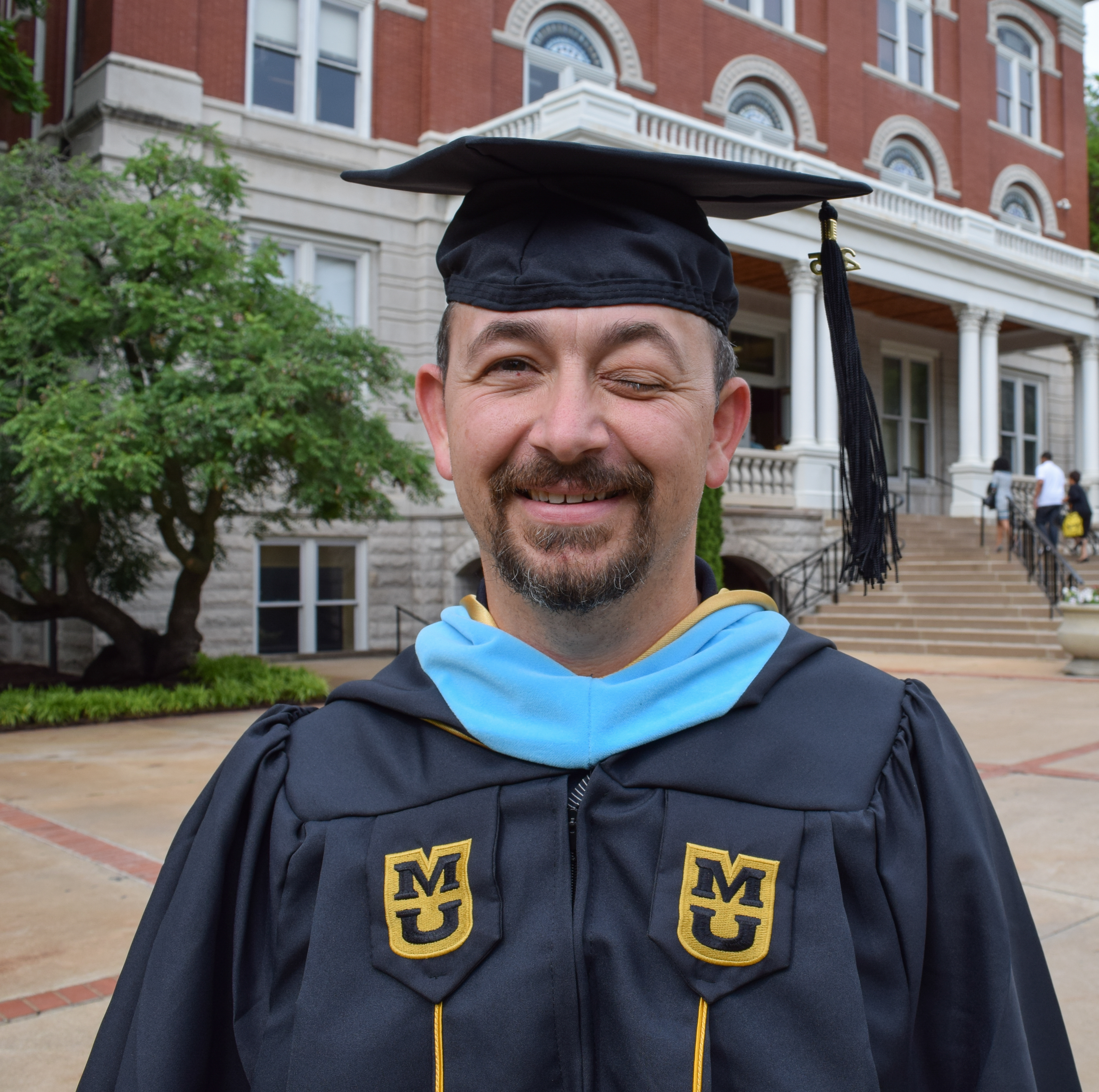 Graduate Brett Greble in his graduation cap and gown.