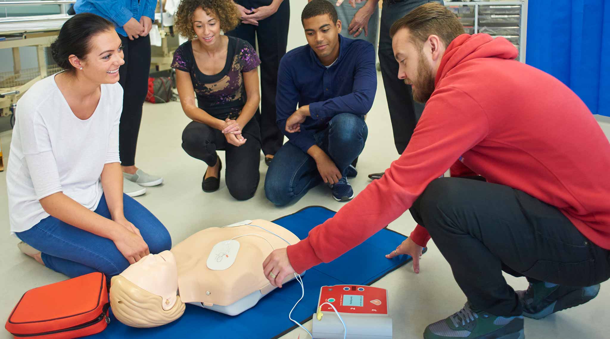 Public health students with a CPR dummy.