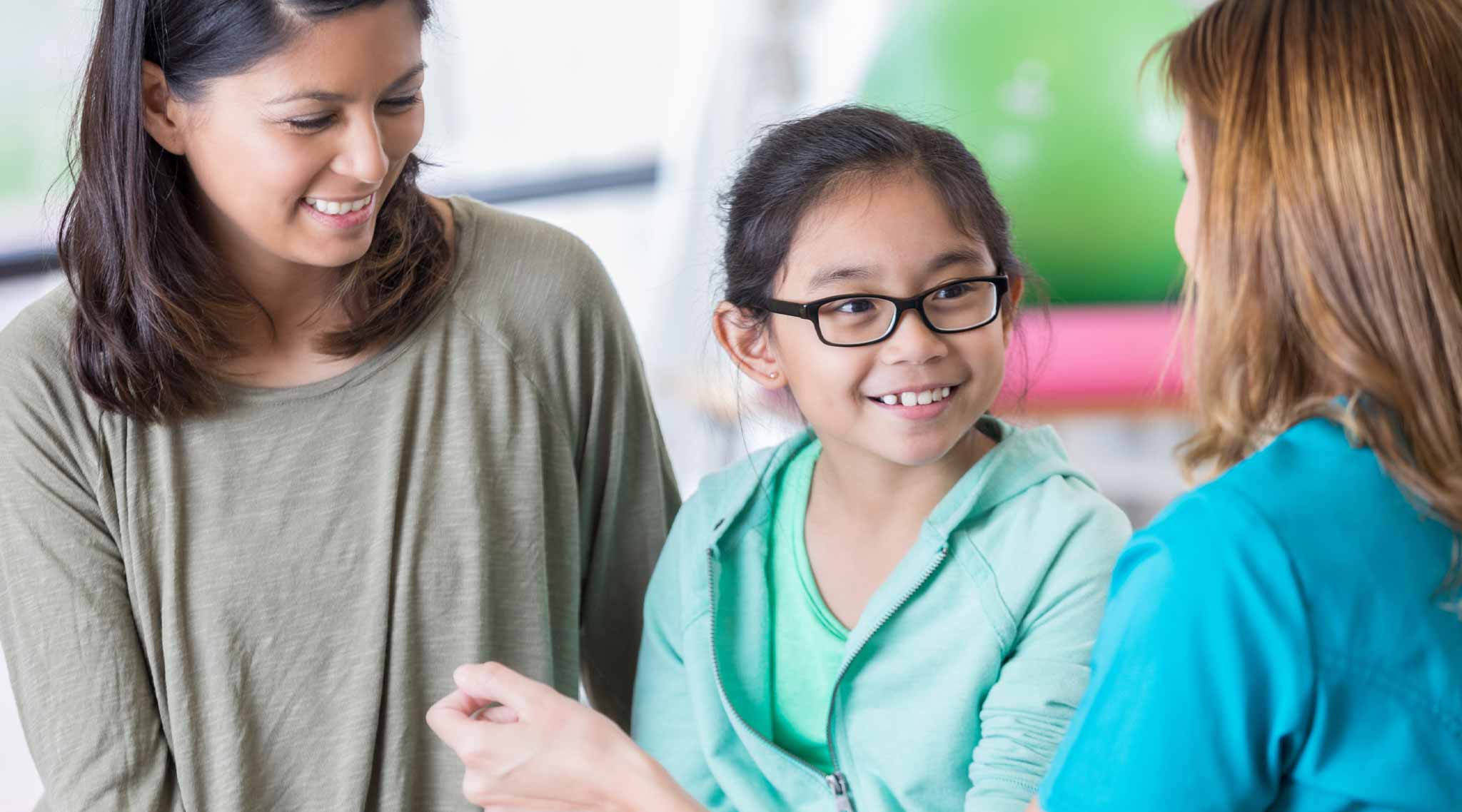 A nurse talking to a young patient.