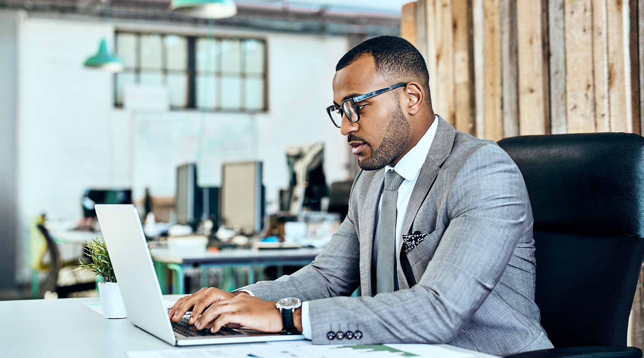 Business professional sitting at a laptop.