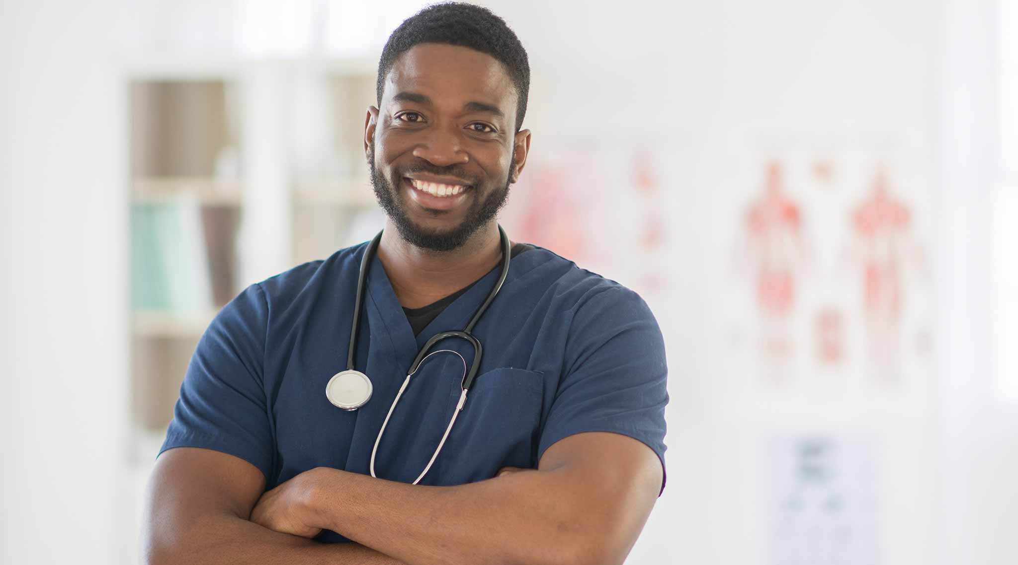 Nurse smiling with arms crossed.
