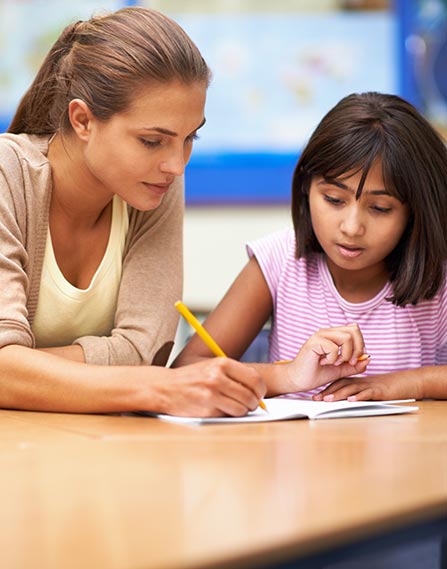 Teacher helping student with school work.