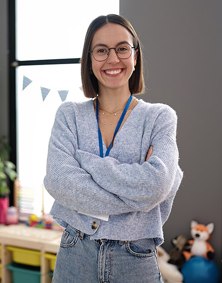 Teacher standing in her classroom.