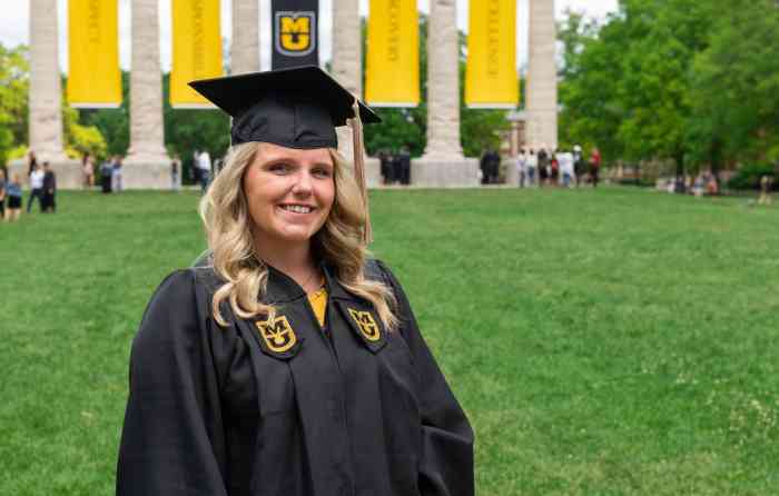 Sarah Swoboda, bachelor's in business administration ’19, wearing her graduation cap and gown, with the Mizzou columns behind her.