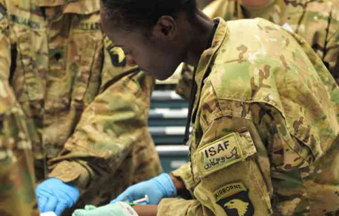 Christine Harris, DNP ’19, in her army uniform working as a nurse.