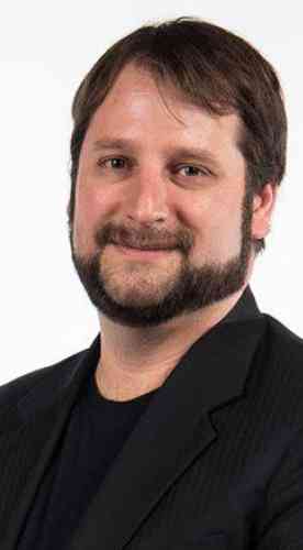 Photo of Brian Maurer: caucasian male in black jacket with short, dark hair and a beard