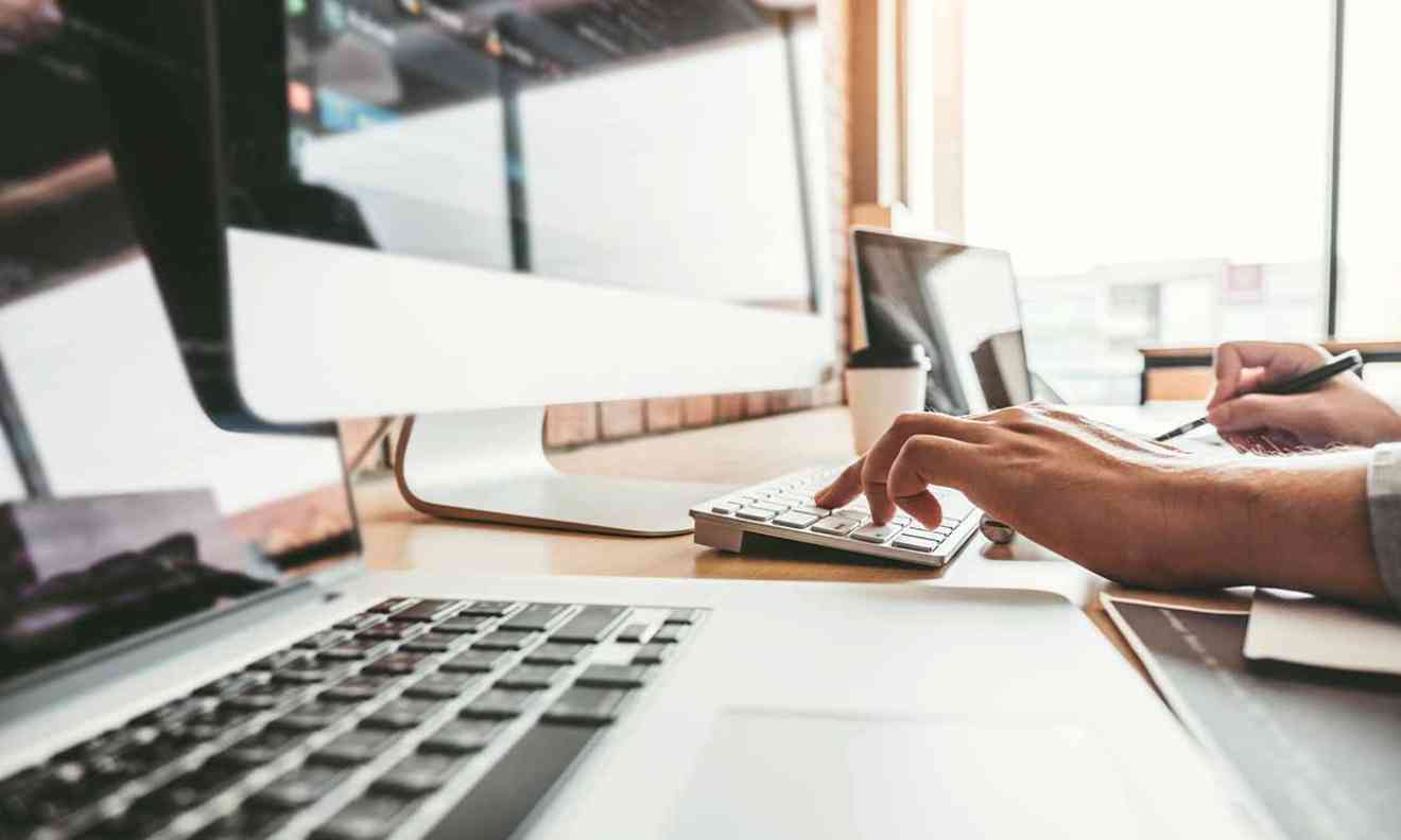 Hands on a laptop.