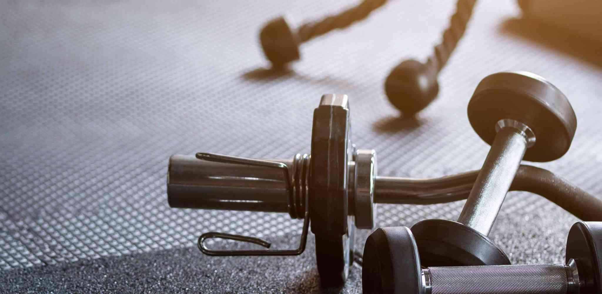 Fitness barbells stacked on rubber floor mats