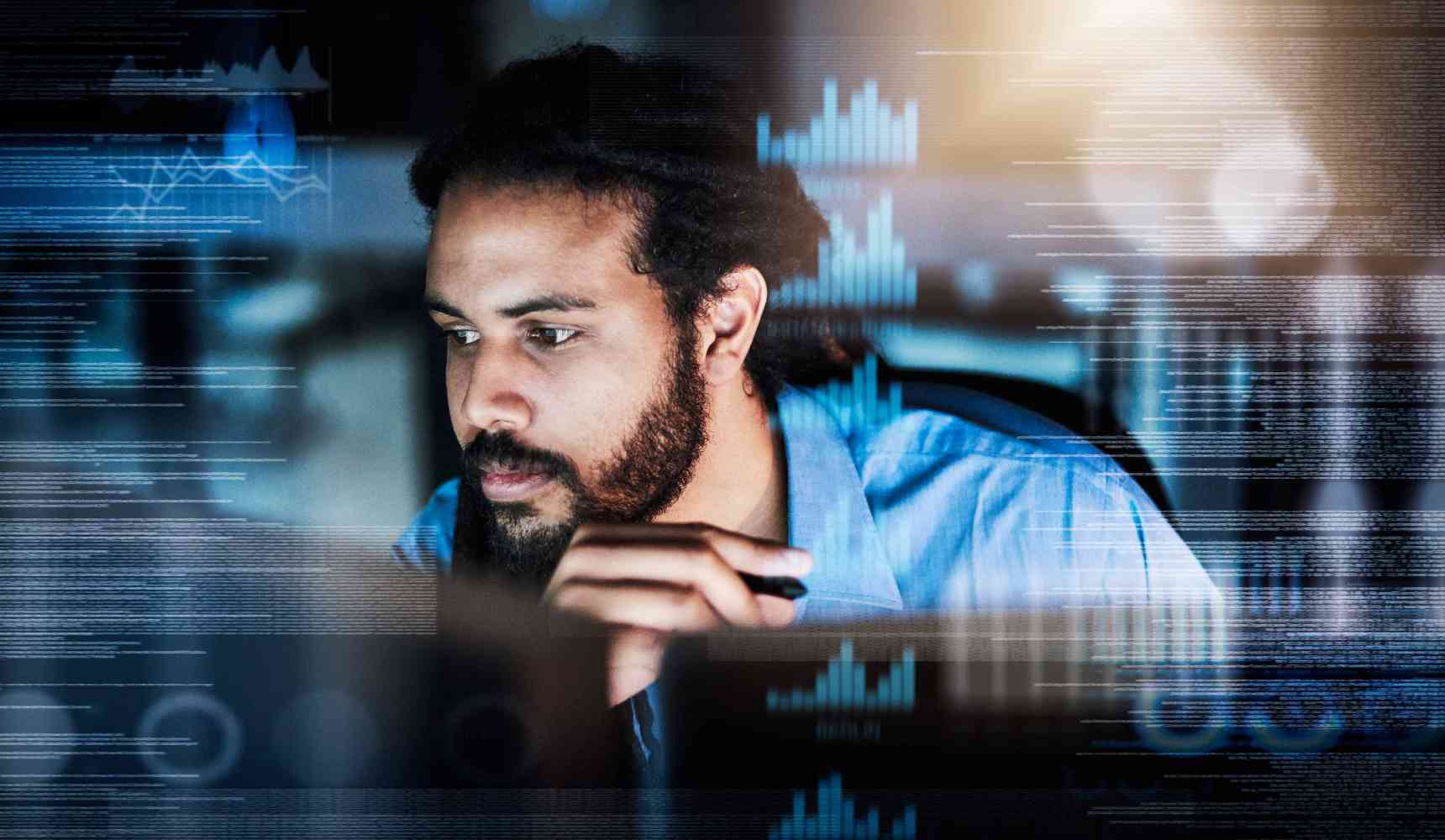 Shot of a programmer working on a computer code at night