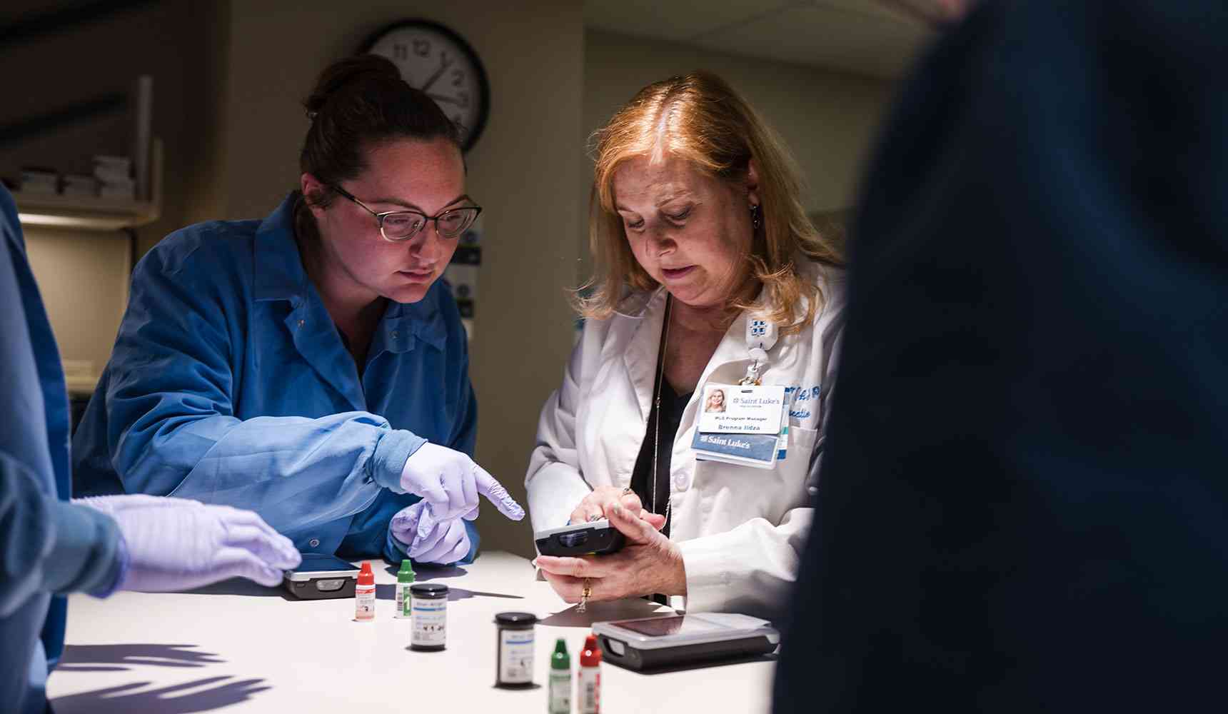 Health professionals reviewing documents.