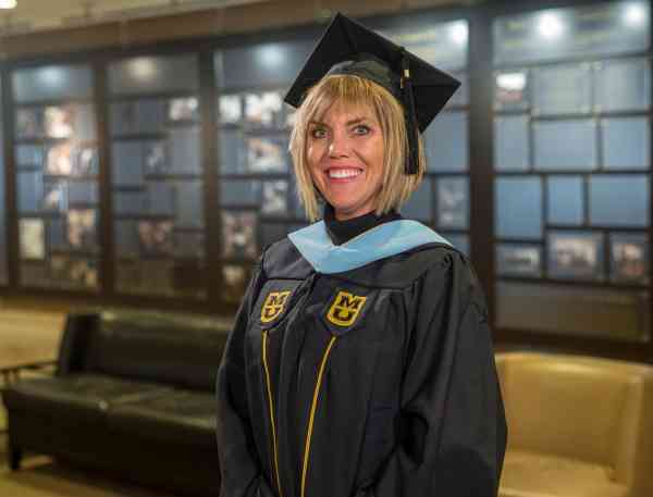 Jennifer Glendenning, art education M Ed, wearing her graduation cap and gown.
