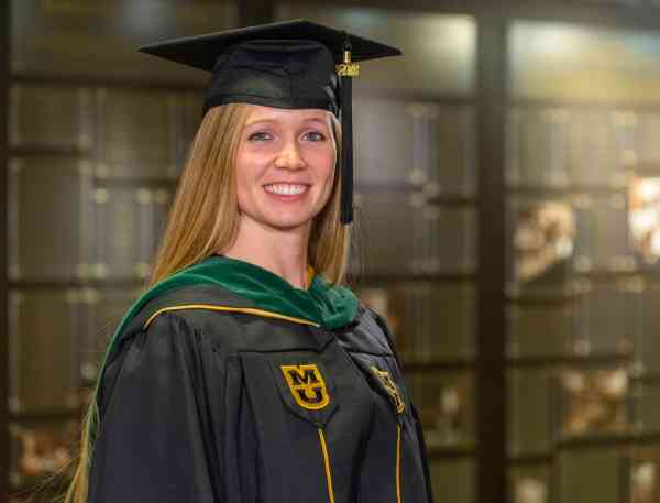 Brooke Clark, MHA, wearing her graduation cap and gown.
