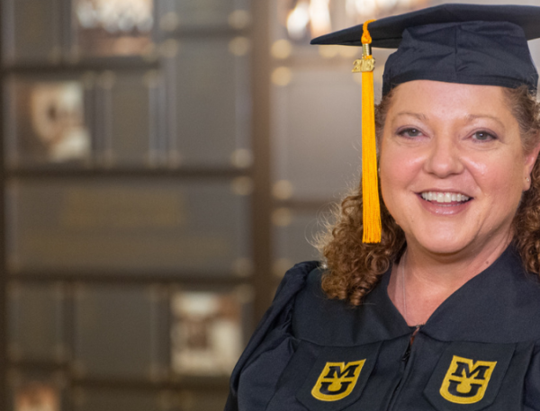 Mary Lammers, BSN, wearing her graduation cap and gown.