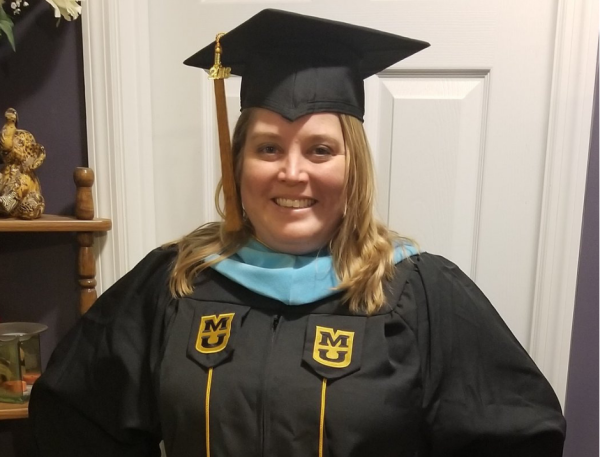 Tanya Deering, EdSp, wearing her graduation cap and gown.