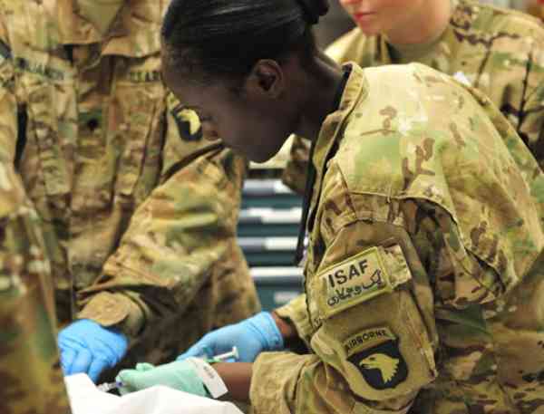 Christine Harris, DNP ’19, in her army uniform working as a nurse.