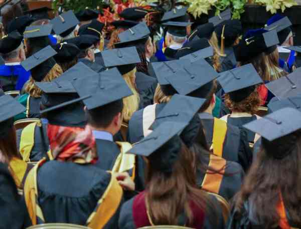 Students in graduation caps at a Mizzou commencement ceremony.