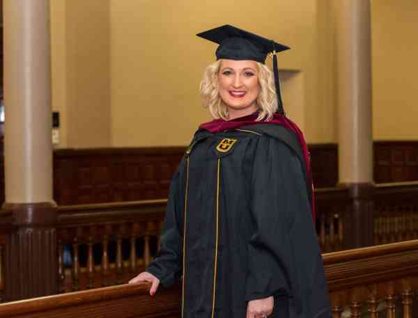 Brandi Sutherland, family and community services MA, in her graduation cap and gown.