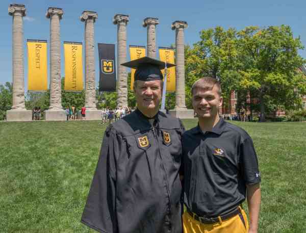 Bill Poteet, BGS, and his son, standing in front of the Mizzou columns.