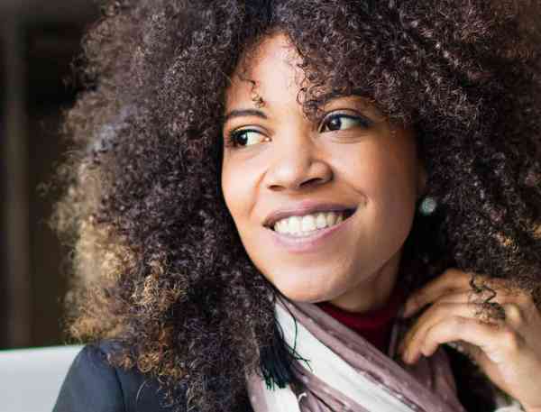 Person smiling and staring off in the distance.