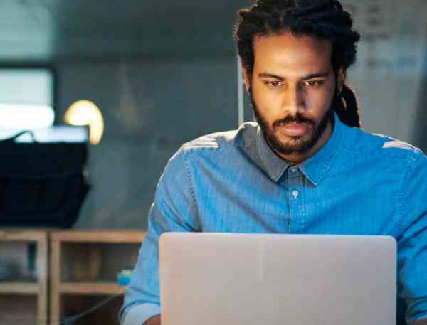 User experience professional working on a laptop.