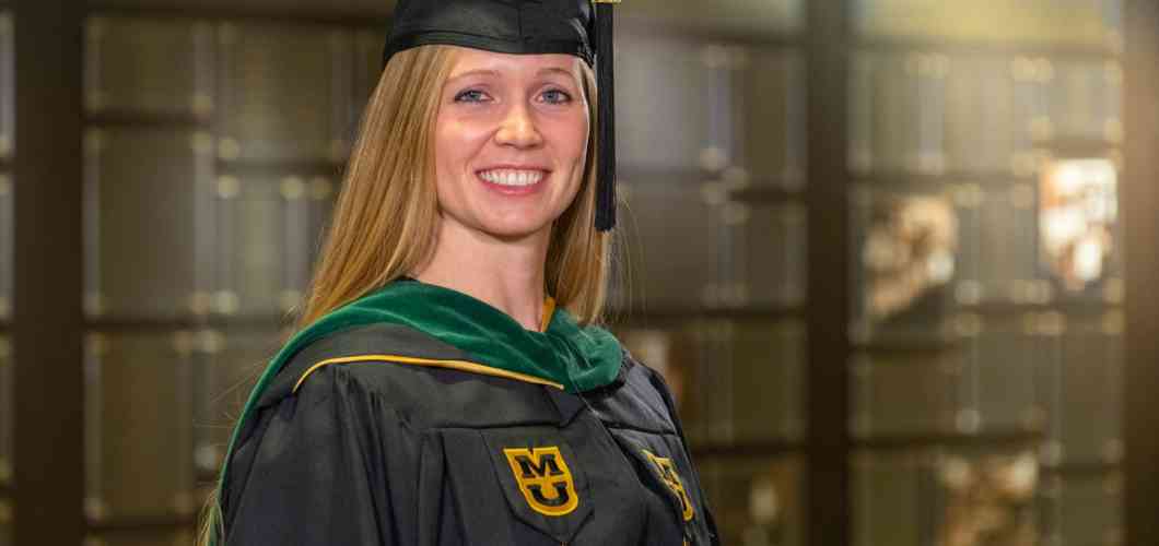 Brooke Clark, MHA, wearing her graduation cap and gown.