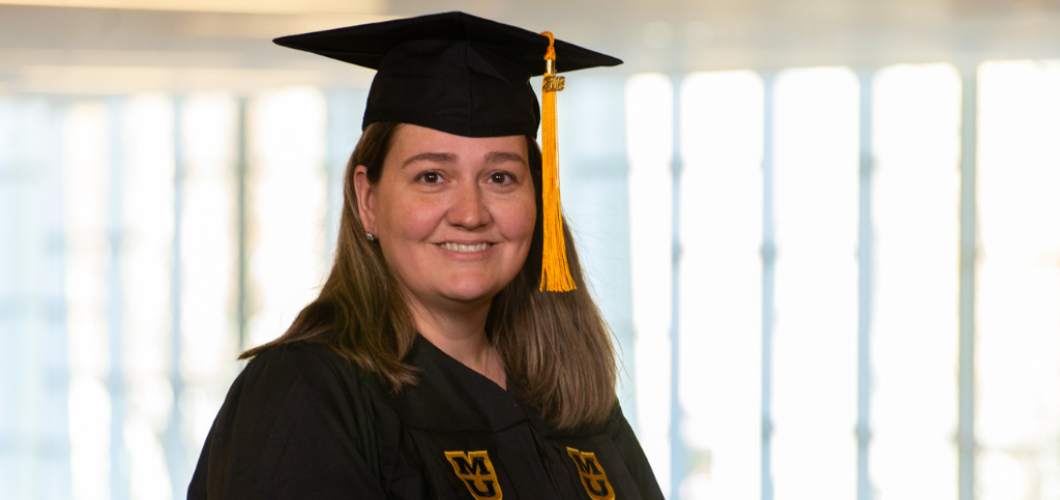 Jennifer Krtek, BSN, wearing her graduation cap and gown.