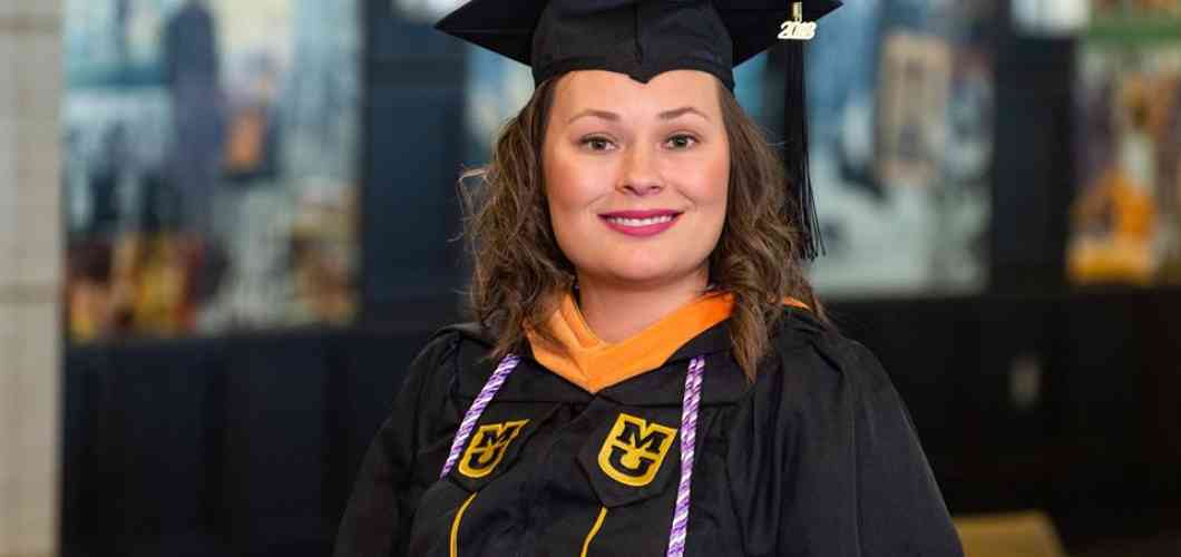 Callie Rinehart, MS in leadership in nursing and health care systems, wearing her graduation cap and gown.