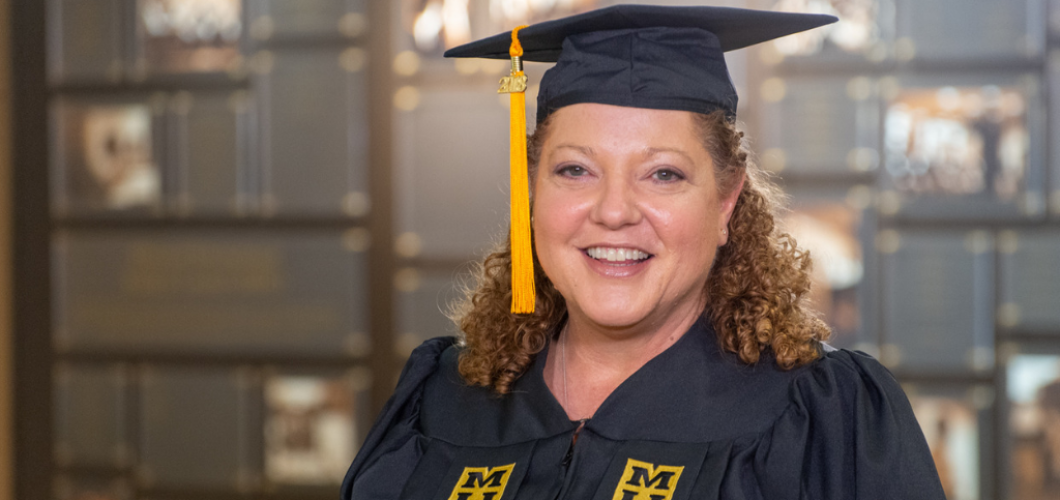 Mary Lammers, BSN, wearing her graduation cap and gown.