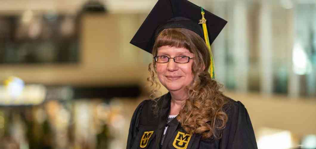 Jennifer Logiudice, radiologic science BHS, wearing her graduation cap and gown at Mizzou's student center.