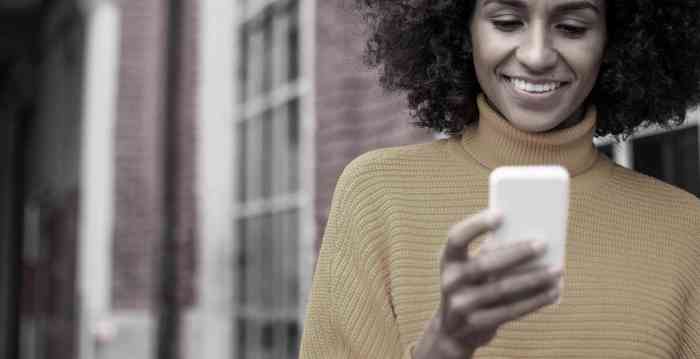 Smiling woman using mobile phone. stock photo.