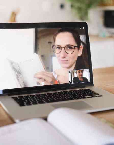 a teacher holding a zoom meeting with a young student