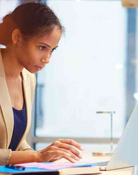Health communication professional working at a laptop.
