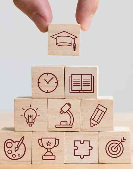 A stack of wooden blocks depicting various career paths.