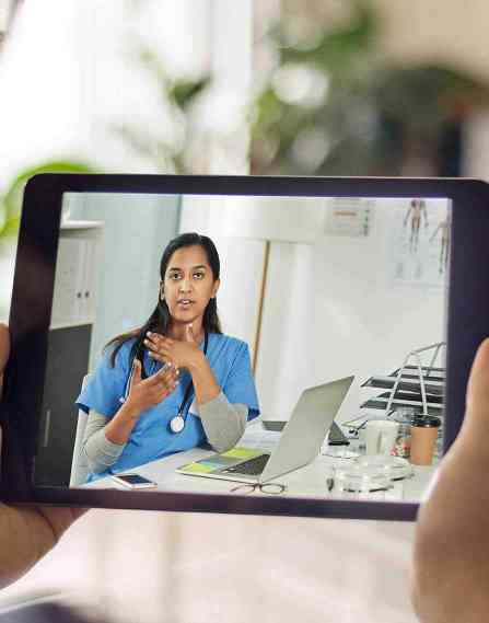 Telehealth professional on a tablet screen.