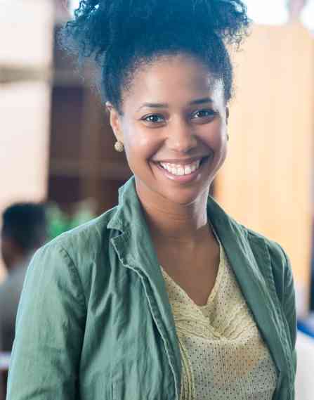 Librarian smiling in a library.