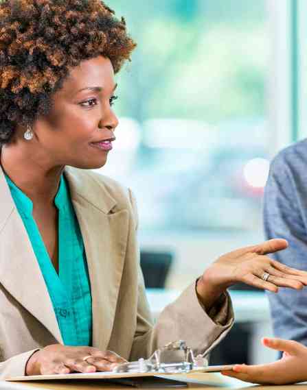 black, female career professional woman talking to a group of young students