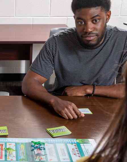 A group of people working on a board game together.