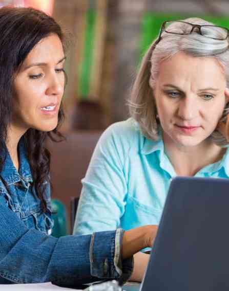Nonprofit professionals working on a laptop together.
