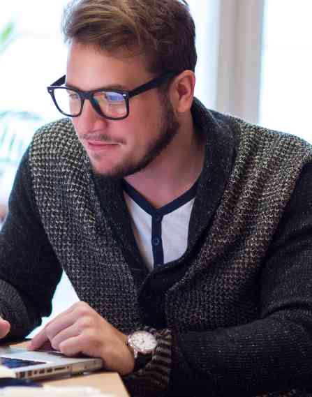 An online educator working at a laptop.