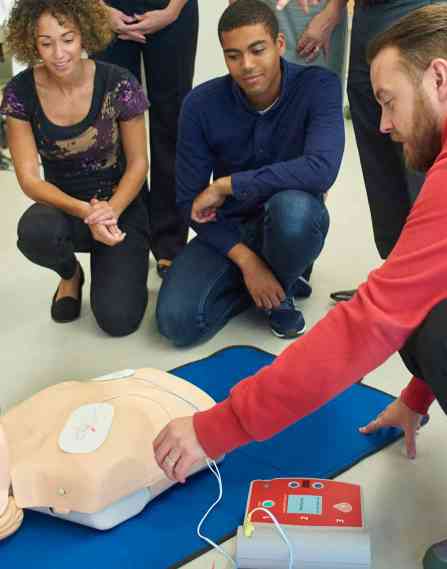 Public health students with a CPR dummy.