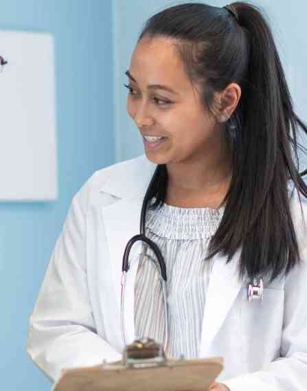 A nurse speaking to a female patient.