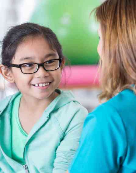 A nurse talking to a young patient.