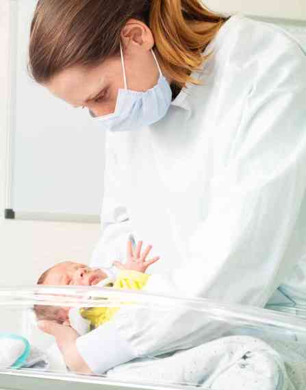 A nurse and neonatal patient.