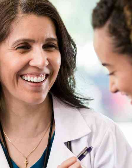 A nurse talking to a patient.