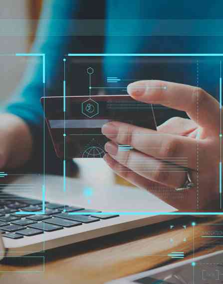 Person looking at credit card with various computer symbols overlaying the image.