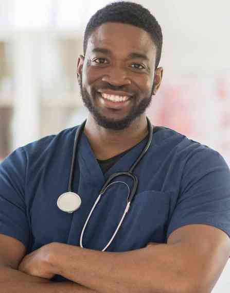 Nurse smiling with arms crossed.