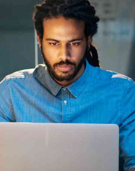User experience professional working on a laptop.