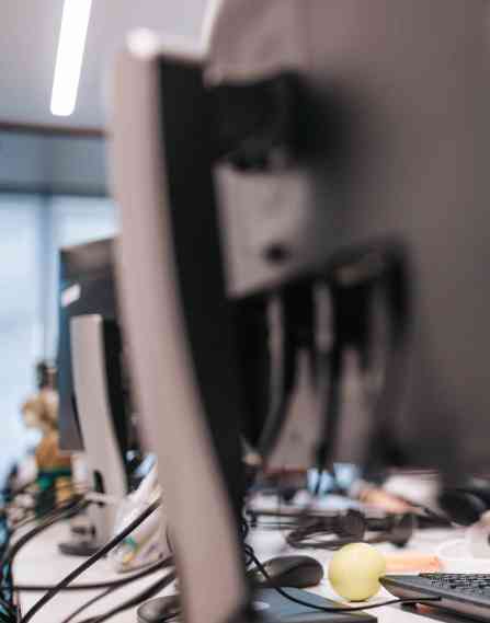 Young black computer programmer coding software while working on PC in the office.