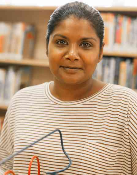 An educator in a library setting.